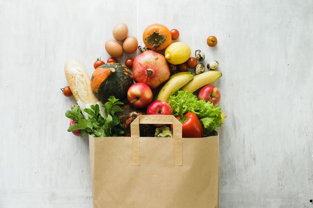 A bag overflowing with fruit and vegetables