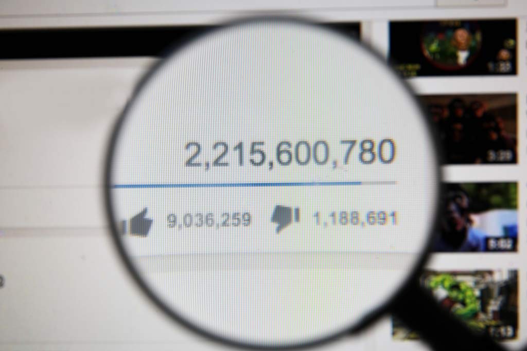 A magnifying glass highlighting a YouTube video with over 2 billion views