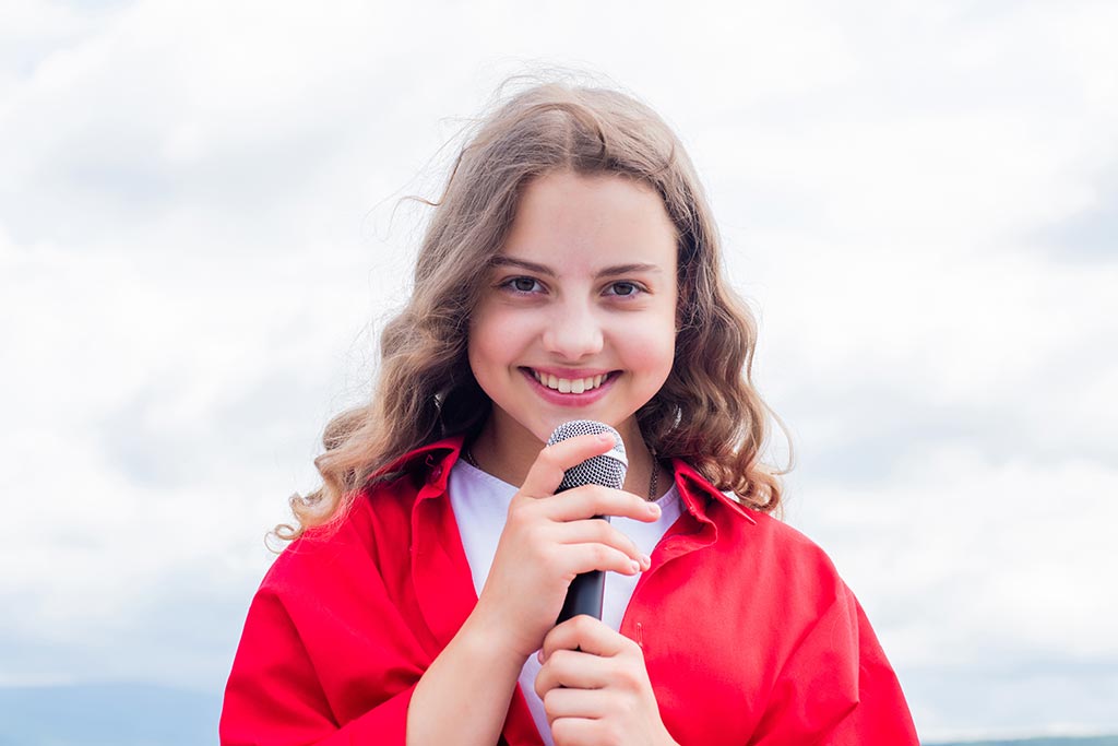 young woman holding a microphone